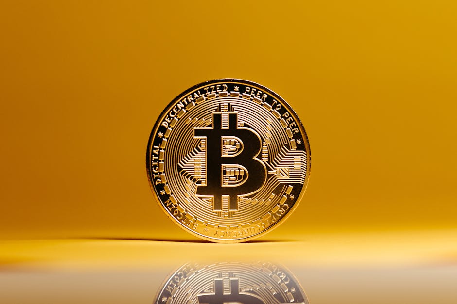 Golden Bitcoin coin showcased against a vibrant yellow background, symbolizing digital currency